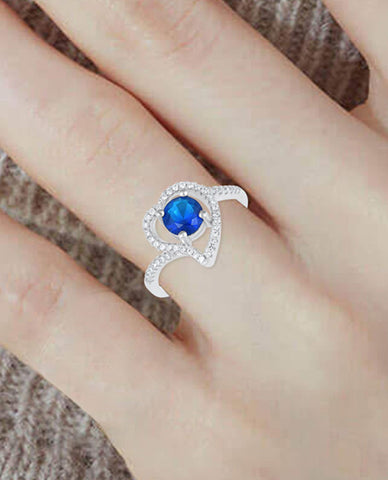 A Glamorous Ring is Crafted in Anti-tarnish 925 Sterling Silver with A Beautiful Blue Stone Surrounded by A Heart Like Design